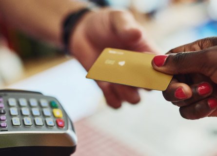 exchange of a credit card in front of a merchant service machine