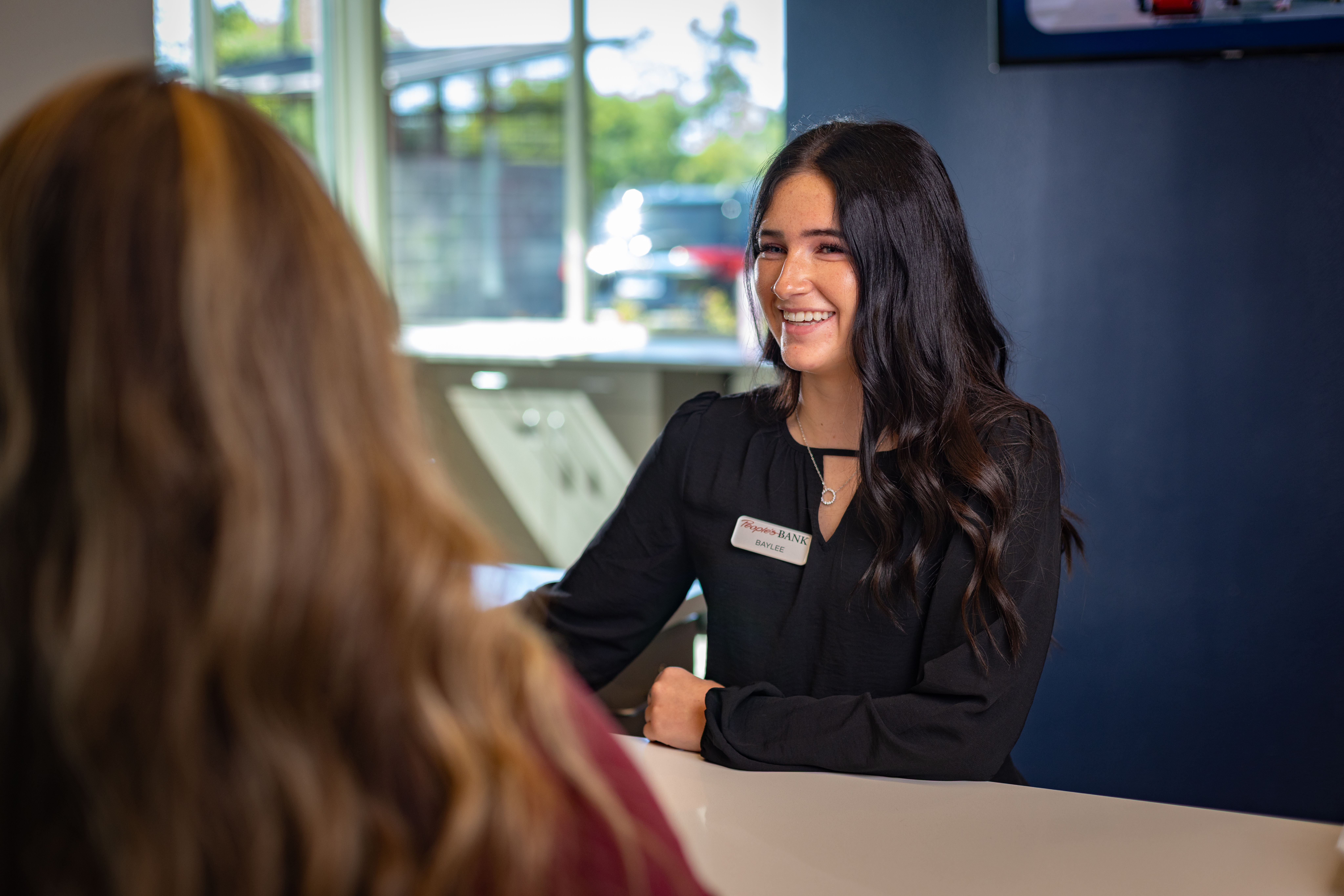 PBOC employee helping a customer.